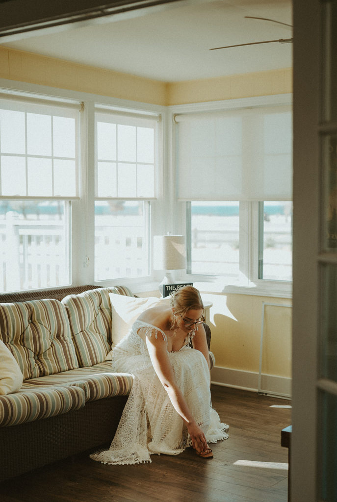 Bride getting ready fall Michigan wedding at a VRBO in Grand haven Michigan across form the state park 